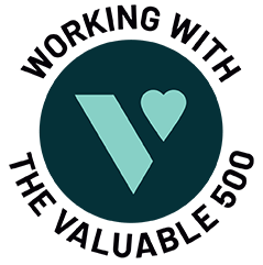 A dark teal circle, with a bright teal logo of the Valuable 500 inside it is shown. Around the circle black text reads ‘Working with the Valuable 500’.
