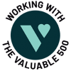 A dark teal circle, with a bright teal logo of the Valuable 500 inside it is shown. Around the circle black text reads ‘Working with the Valuable 500’.